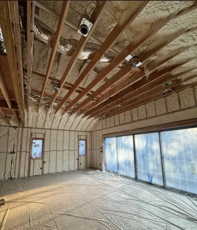 Interior walls and ceiling insulated with spray foam during new construction in Livonia